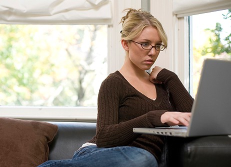 Thoughtful woman using laptop