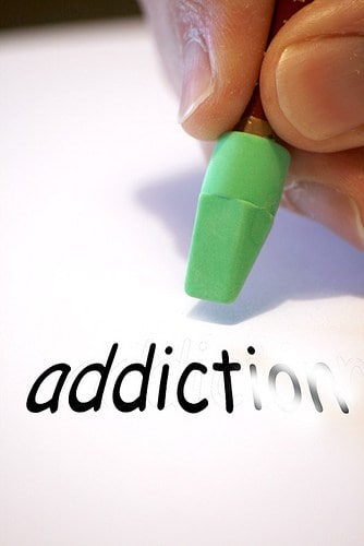 erasing the word addiction on paper